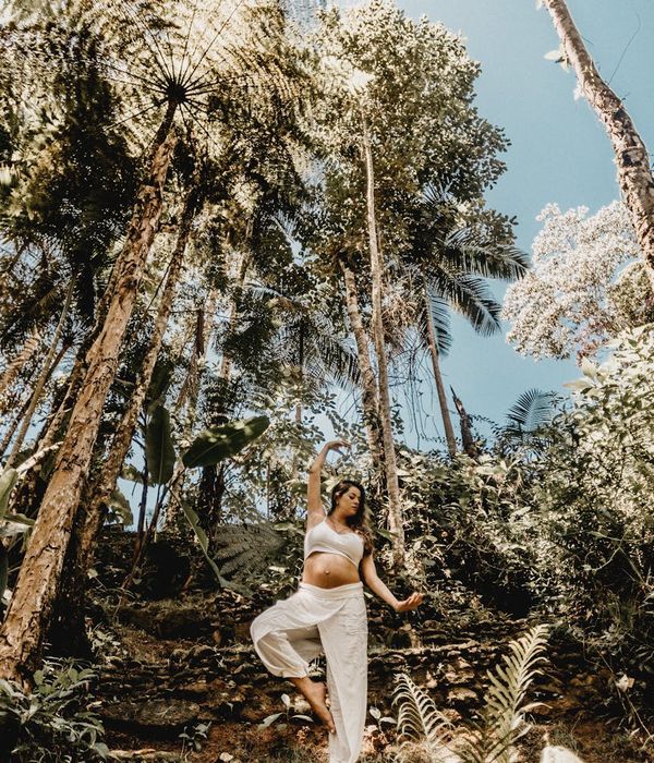 Woman performing a gentle, flowing yoga pose in a calm environment.